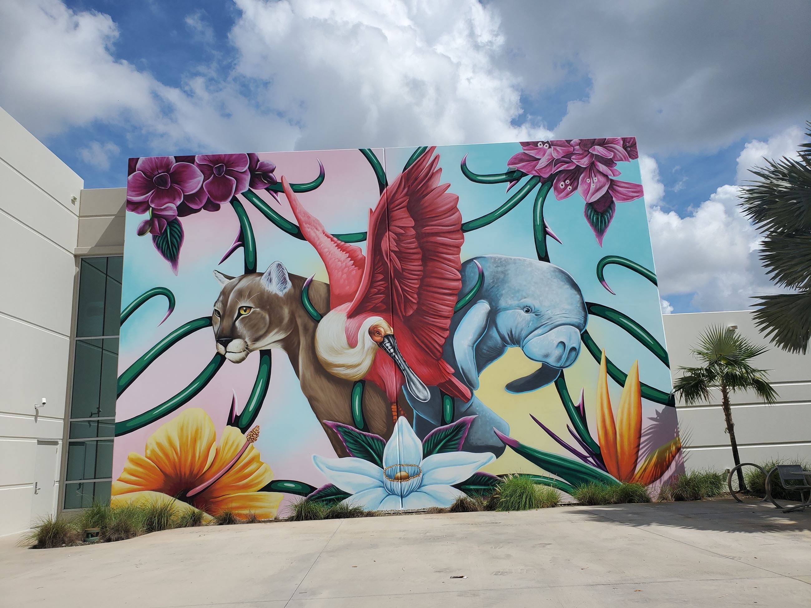 Picture of completed mural with vibrant colors depicting animals and flowers
